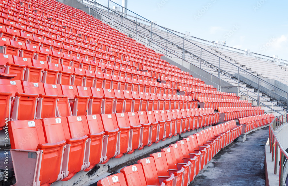 Fototapeta premium Empty orange seats at stadium,Rows of seat on a soccer stadium
