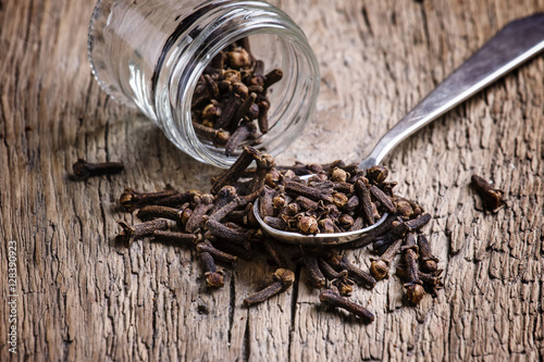 Cloves, old wooden background, selective focus