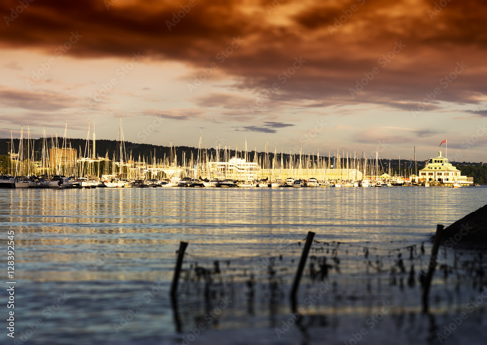 Sunset Oslo yacht club near coast background