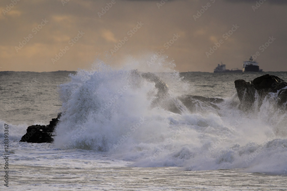 Sea storm at sunset