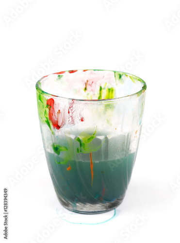 Glass smudged with paint and dirty water isolated on white Stock