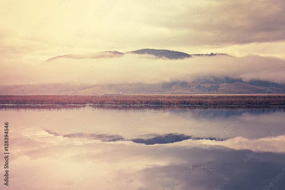 Obraz premium Retro toned foggy morning over lake in Grand Teton National Park, Wyoming, USA.