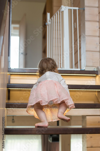 Beautiful little girl walking upstairs