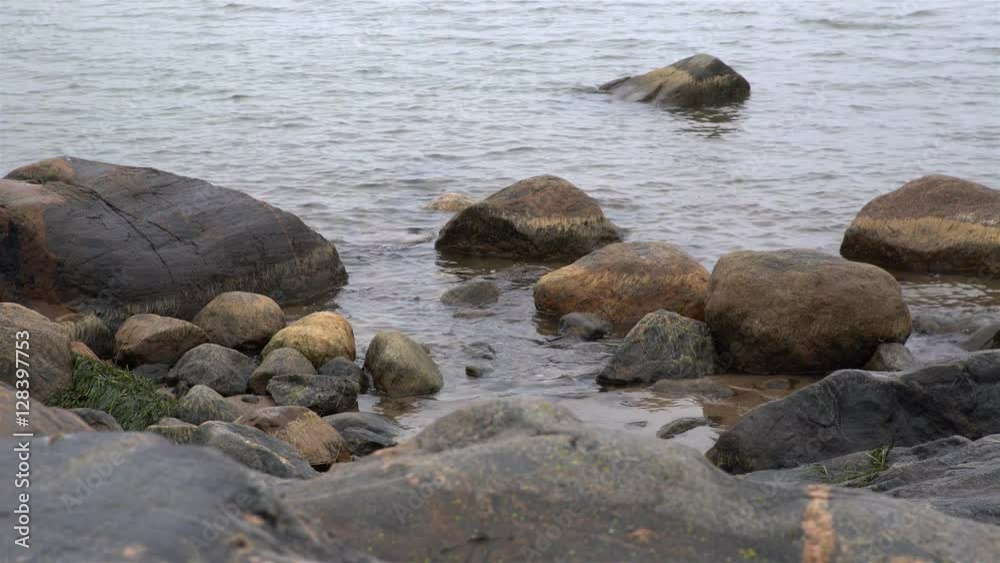 Severe Gray Stones And Cold Waves Of The North Sea. Dolly Shot. Severe Gray Stones And Cold Waves Of The North Sea. Dolly Shot.