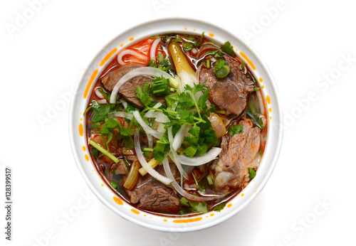 Bun Ho Hue or Vietnamese vermicelli noodles with beef on a white background