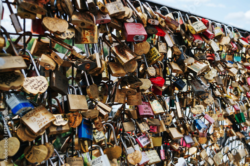 PARIS - JUNE 26: Love lockers at Pon des Arts bridge across Seine river. They symbolize love for ever.