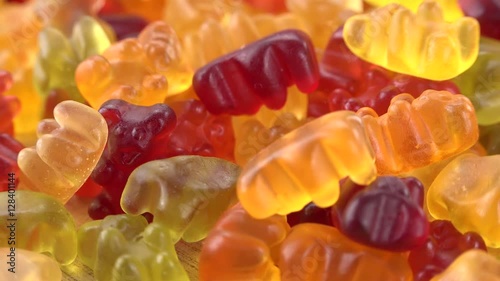 Gummy Bears rotating on a wooden plate (not loopable; 4K)