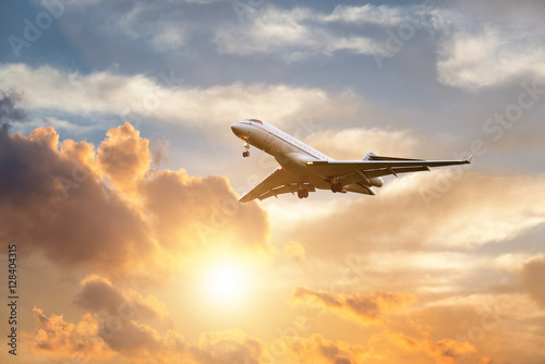 Fotografie Airplane landing at sunrise