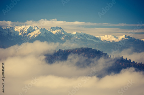 Snowy Tatra mountains over clouds, Poland