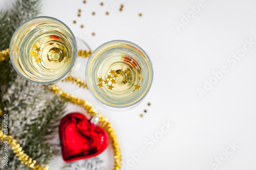 glasses of champagne and Christmas ornaments top view