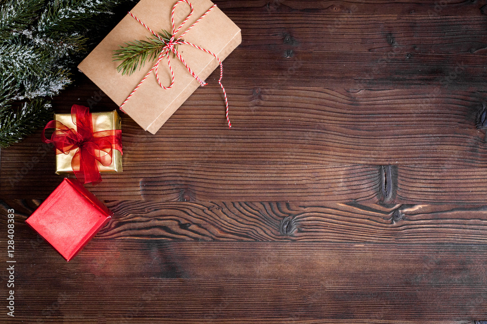packaging christmas gifts in boxes on wooden background top view