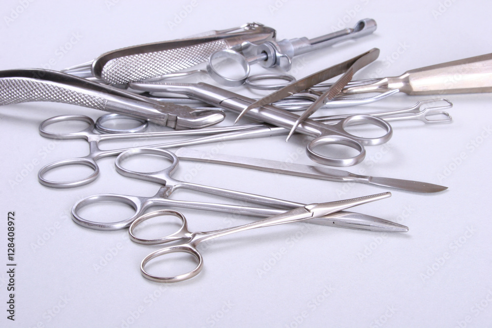 surgical instruments and tools including scalpels, forceps tweezers arranged on a table for surgery surgical instruments and tools including scalpels, forceps tweezers arranged on a table for surgery