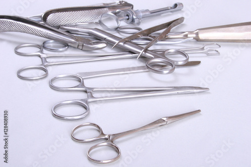 surgical instruments and tools including scalpels  forceps  tweezers arranged on a table for  surgery