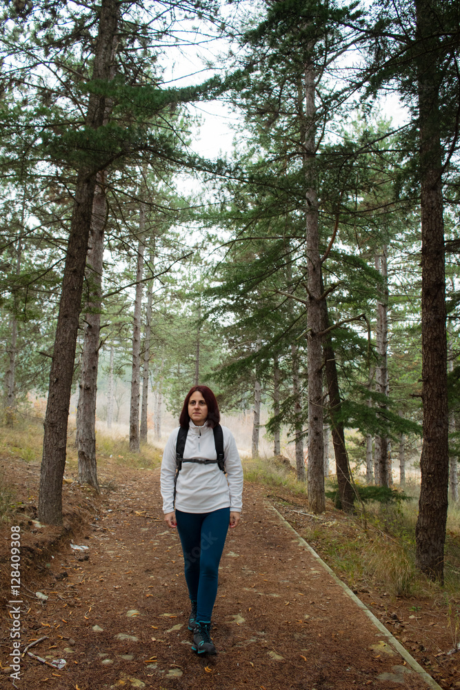 Woman hiking in the forest Woman hiking in the forest