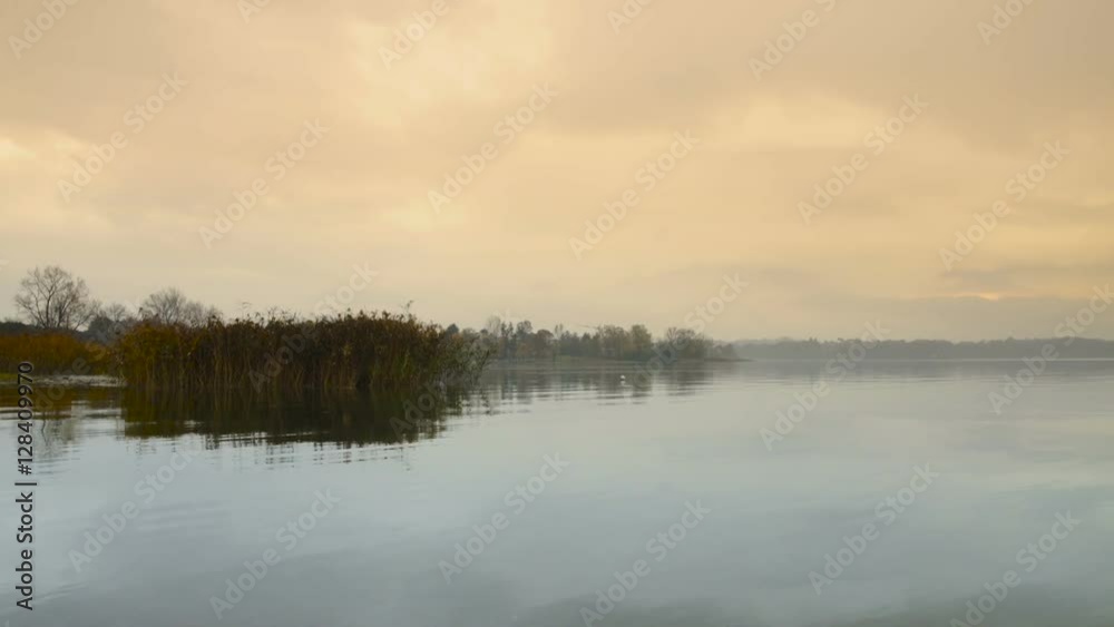 Sunrise on the quiet lake and cane thicket Sunrise on the quiet lake and cane thicket