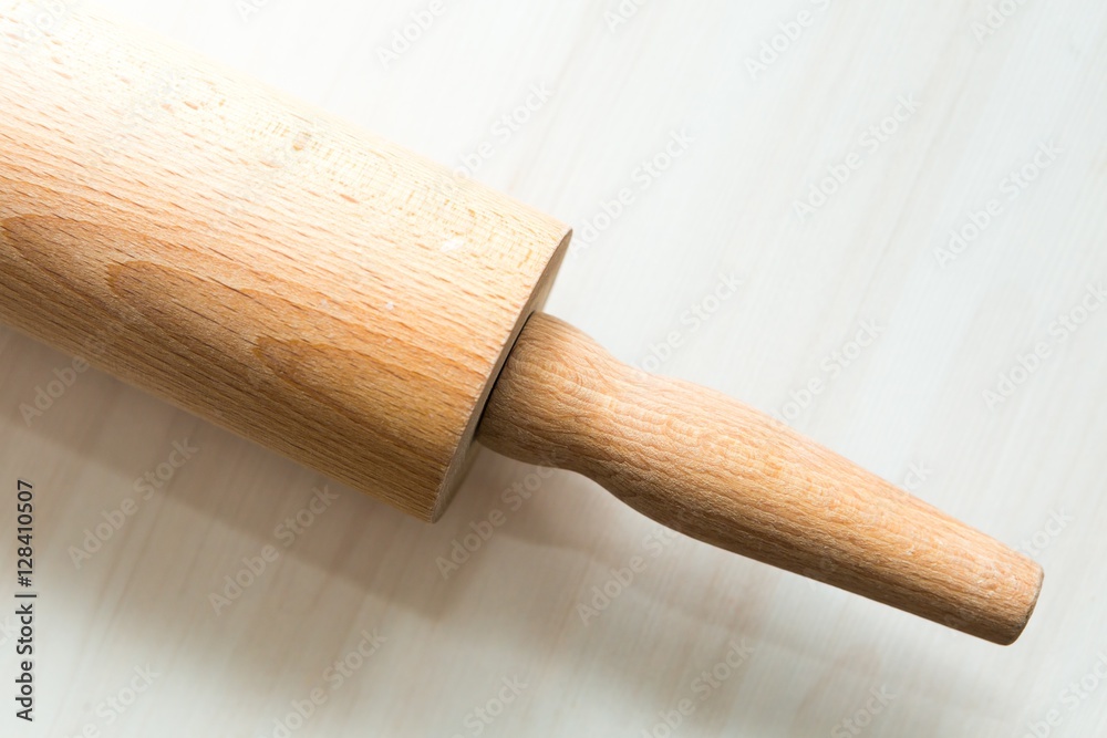 Close up of rolling pin lying on wooden table Close up of rolling pin lying on wooden table