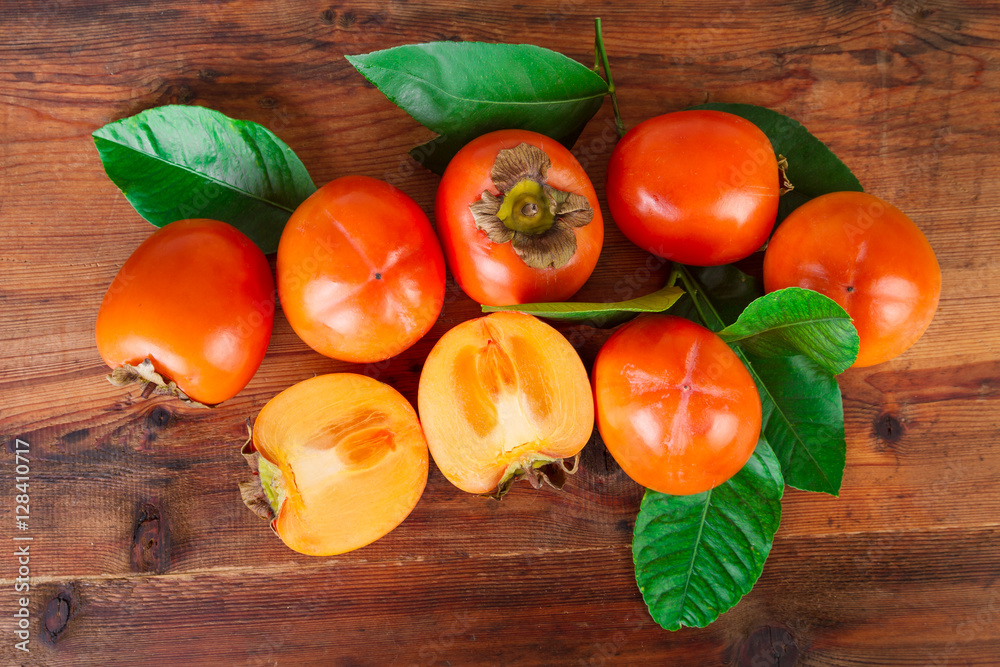 Persimmons kaki fruits on rustic table. Top view. Persimmons kaki fruits on rustic table. Top view.