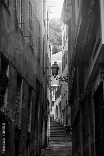 Beautiful view of scenic narrow alley street with historic traditional houses in an old town in Europe with blue sky and clouds in summer sunny day  with retro vintage Instagram warm filter effect