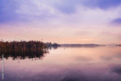 Sunrise on the quiet lake and reeds