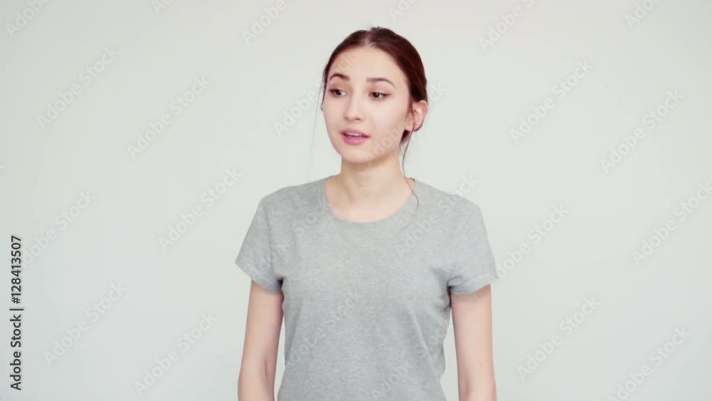 Close-up portrait girl teenager 14 years old sneezes and smiling at camera on white background. Slow motion from SonyA6300 Close-up portrait girl teenager 14 years old sneezes and smiling at camera on white background. Slow motion from SonyA6300
