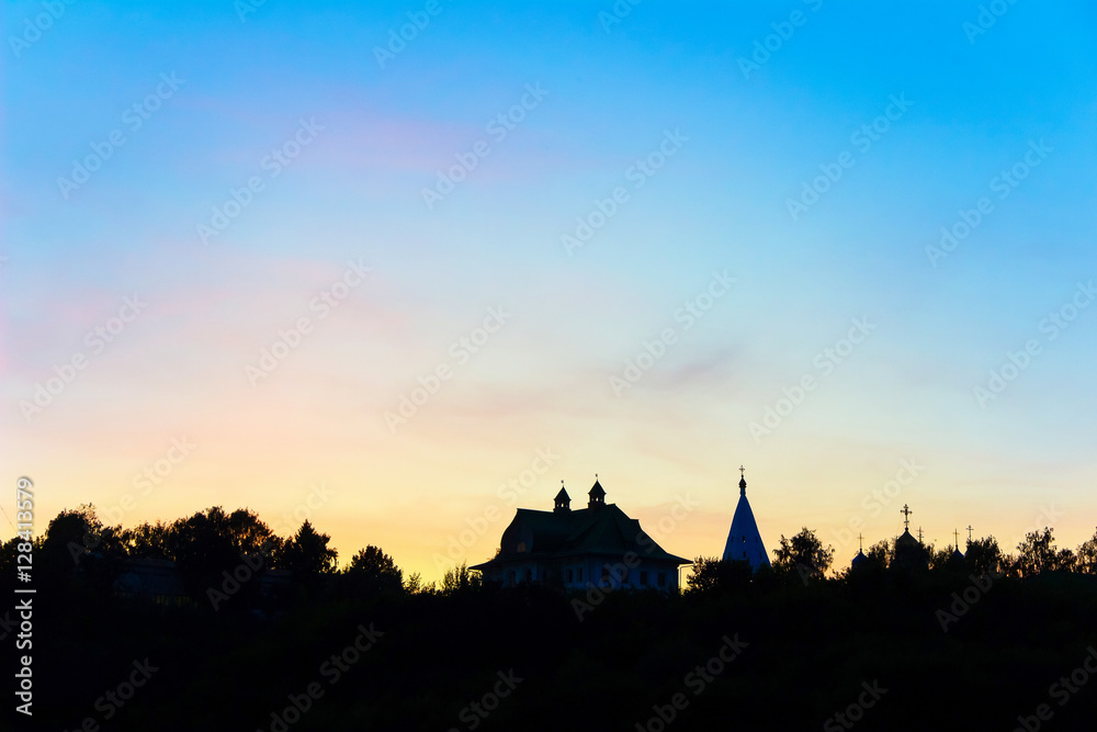 silhouettes of churches at sunset