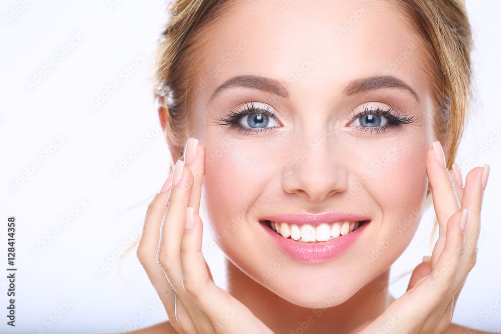 Young woman touching her face isolated on white background Young woman touching her face isolated on white background