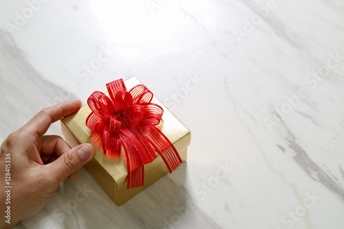 gift giving,man hand holding a gift box in a gesture of giving o