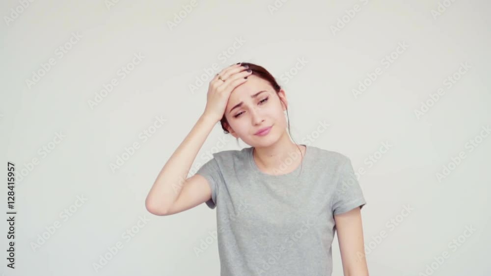 Headache. Portrait girl teenager 14 years old on white background. Slow motion from Sony A6300 Headache. Portrait girl teenager 14 years old on white background. Slow motion from Sony A6300