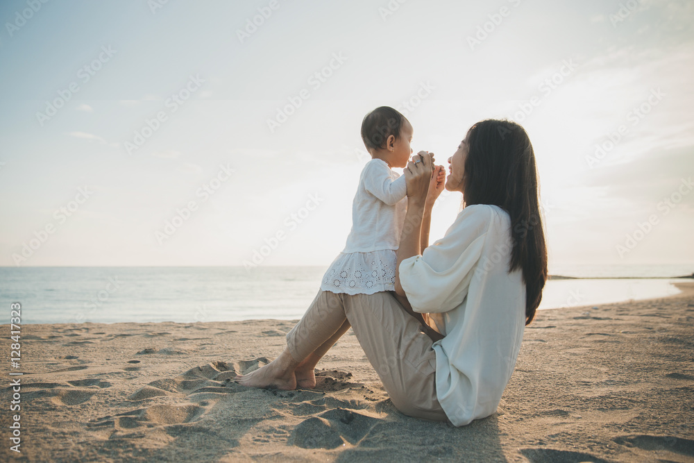 mother is teaching her daughter walks on the beach mother is teaching her daughter walks on the beach