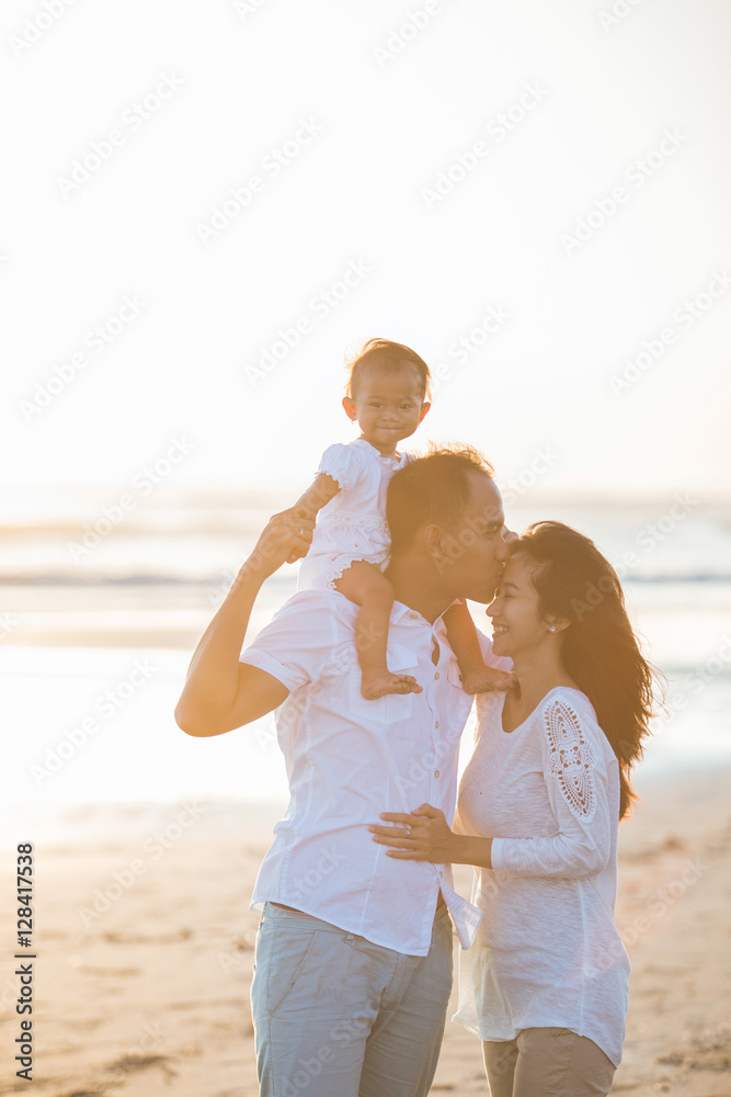 happy family at the beach loving each other happy family at the beach loving each other
