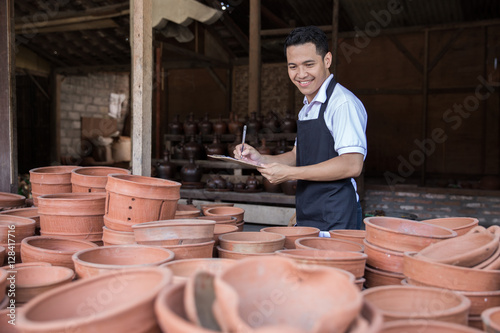 male potter checking of his pottery product