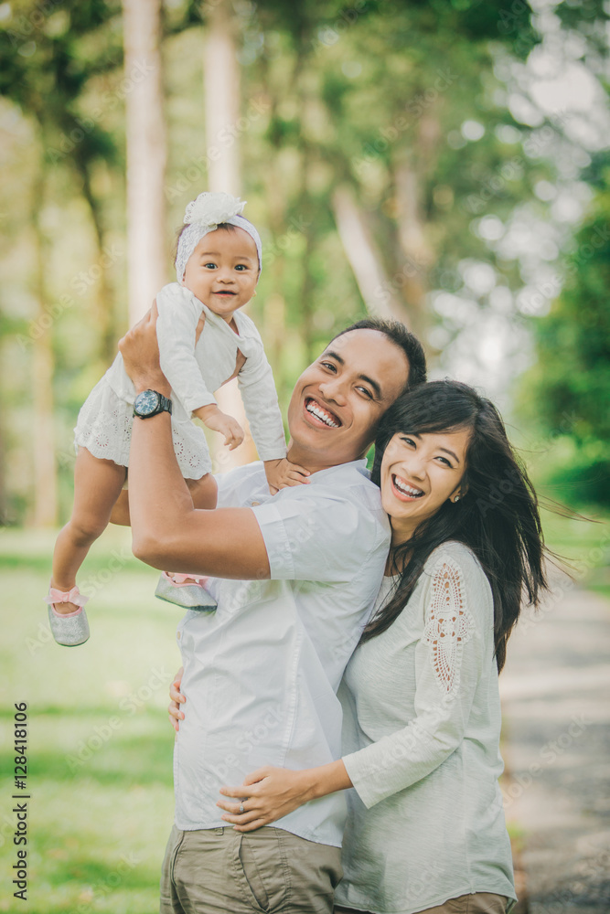 parent with their cute baby in the park having fun together parent with their cute baby in the park having fun together