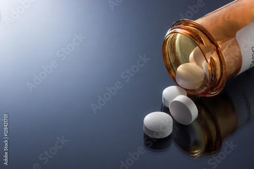 Pills spilling out of bottle