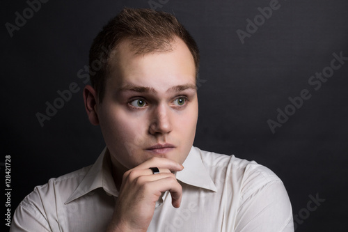 Young handsome minded man thinking to find way to solve problem