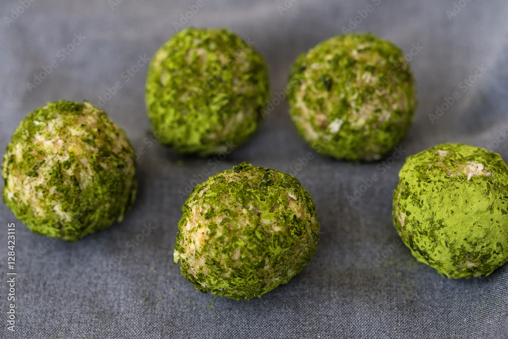 Sweets of green color, balls with addition of matcha of tea, healthy nutrition, crude food, crude candies with addition of matcha of tea Sweets of green color, balls with addition of matcha of tea, healthy nutrition, crude food, crude candies with addition of matcha of tea