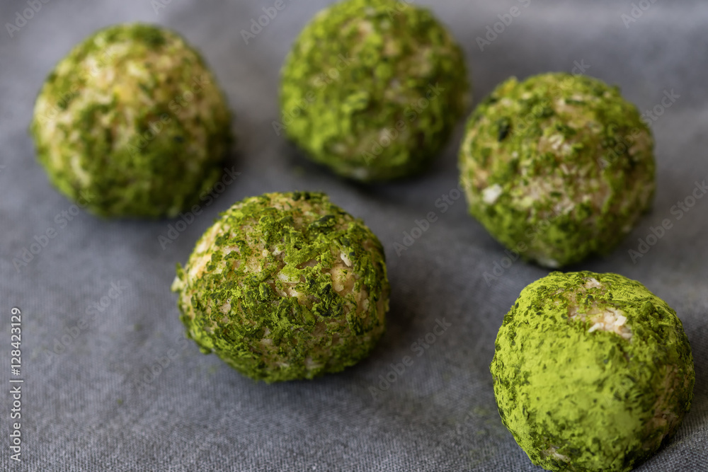 Sweets of green color, balls with addition of matcha of tea, healthy nutrition, crude food, crude candies with addition of matcha of tea Sweets of green color, balls with addition of matcha of tea, healthy nutrition, crude food, crude candies with addition of matcha of tea