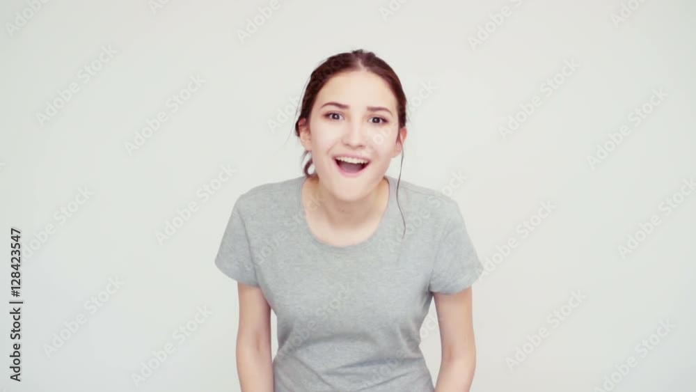 Surprise and joy. Close-up portrait cheerful girl 14 years old teenager looking at camera on white background. Slow motion from Sony A6300 Surprise and joy. Close-up portrait cheerful girl 14 years old teenager looking at camera on white background. Slow motion from Sony A6300