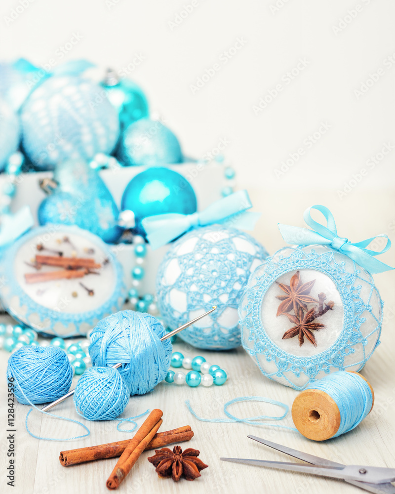 White beautiful Christmas balls decorated with a blue knitted pattern on wooden background with copy space White beautiful Christmas balls decorated with a blue knitted pattern on wooden background with copy space