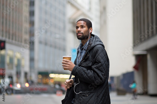 Young African American professional walking to work in the city
