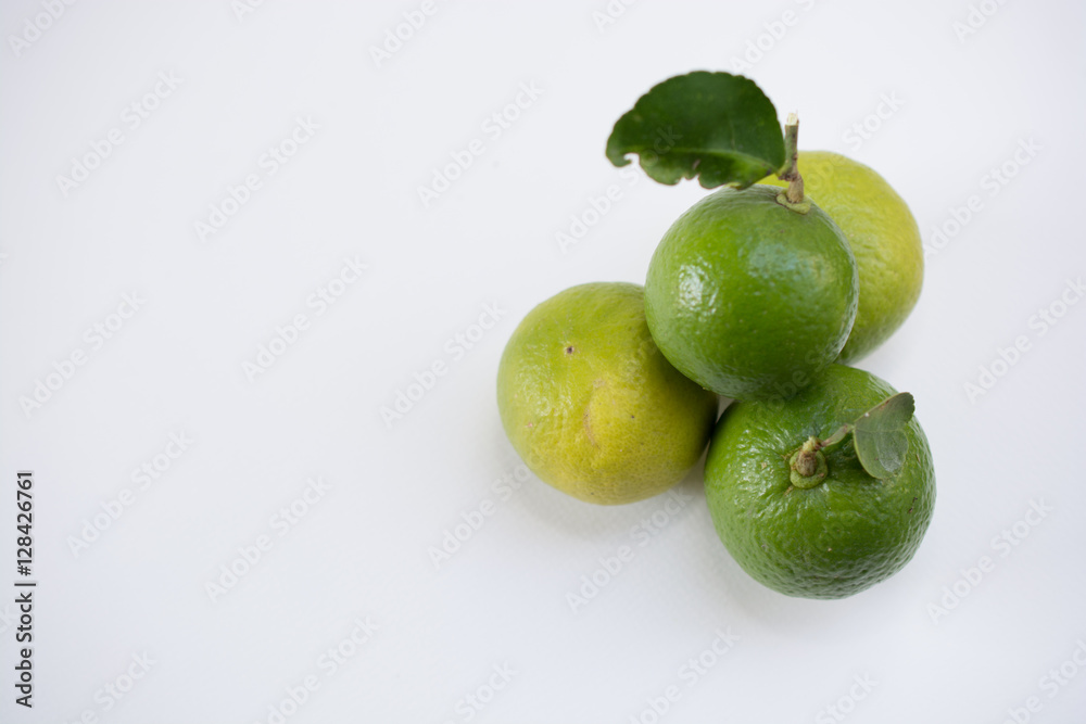 .Keep fresh lemon sour vitamin C from fresh green on a white bac .Keep fresh lemon sour vitamin C from fresh green on a white bac