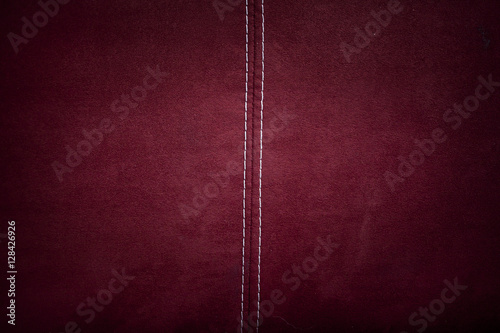 Red alcantara leather background texture with stitching photo