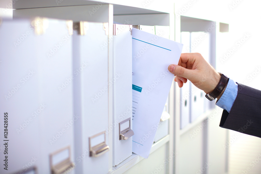 File folders, standing on shelves in the background File folders, standing on shelves in the background