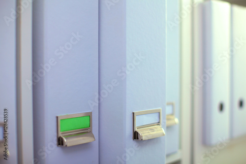 File folders, standing on  shelves in the background © lenetsnikolai