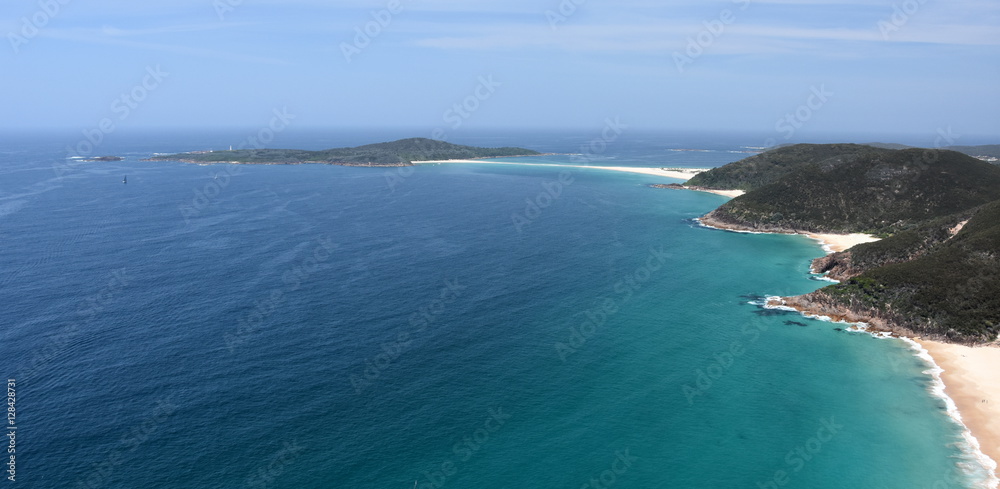Shark Island and coastline of Shoal bay on a sunny day from Mount Tomaree Lookout (Central Coast, NSW, Australia)