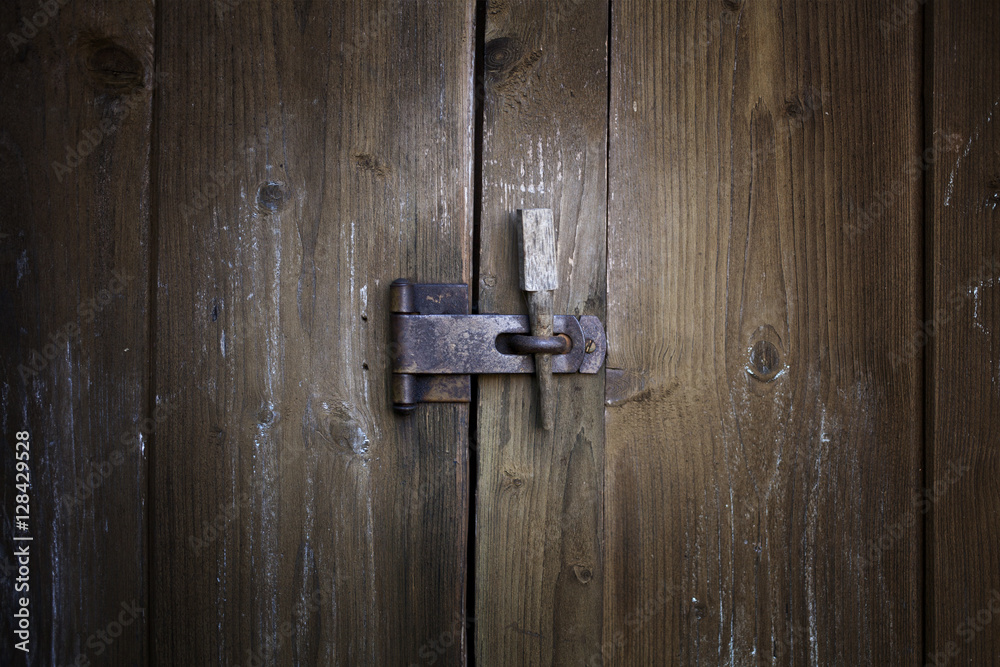 Old weathered wood planks doors with old rusty lock. Texture for background. Old weathered wood planks doors with old rusty lock. Texture for background.