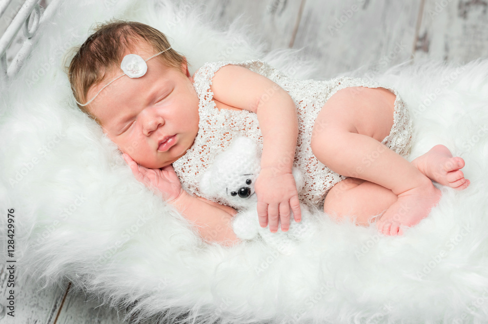 cute sleeping newborn baby on cot with fluffy blanket cute sleeping newborn baby on cot with fluffy blanket