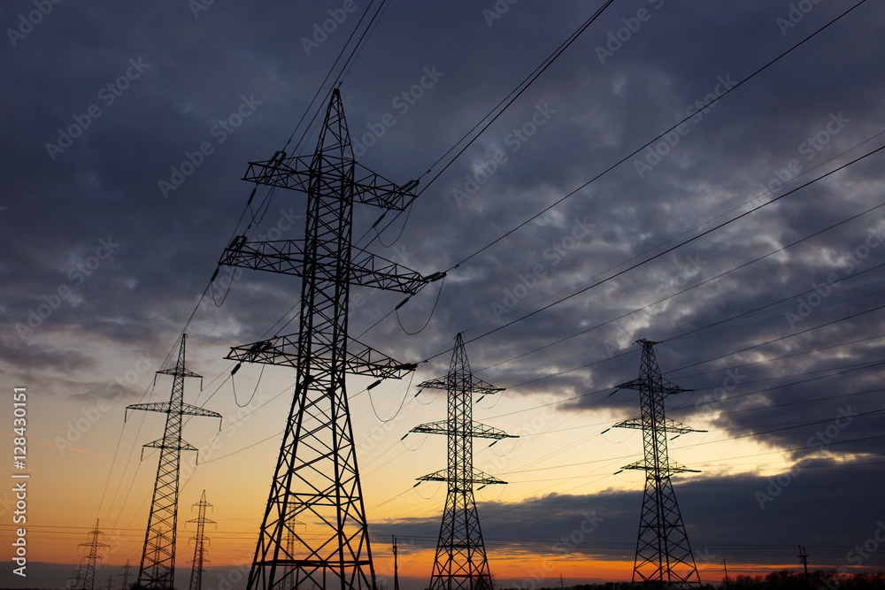 Metal Bearing high voltage power line at sunset