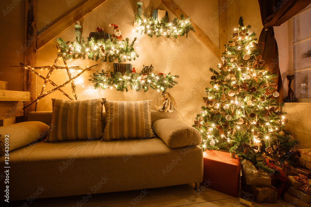 Calm image of interior modern home living room decorated christmas tree and gifts, sofa, table covered with blanket. Calm image of interior modern home living room decorated christmas tree and gifts, sofa, table covered with blanket.
