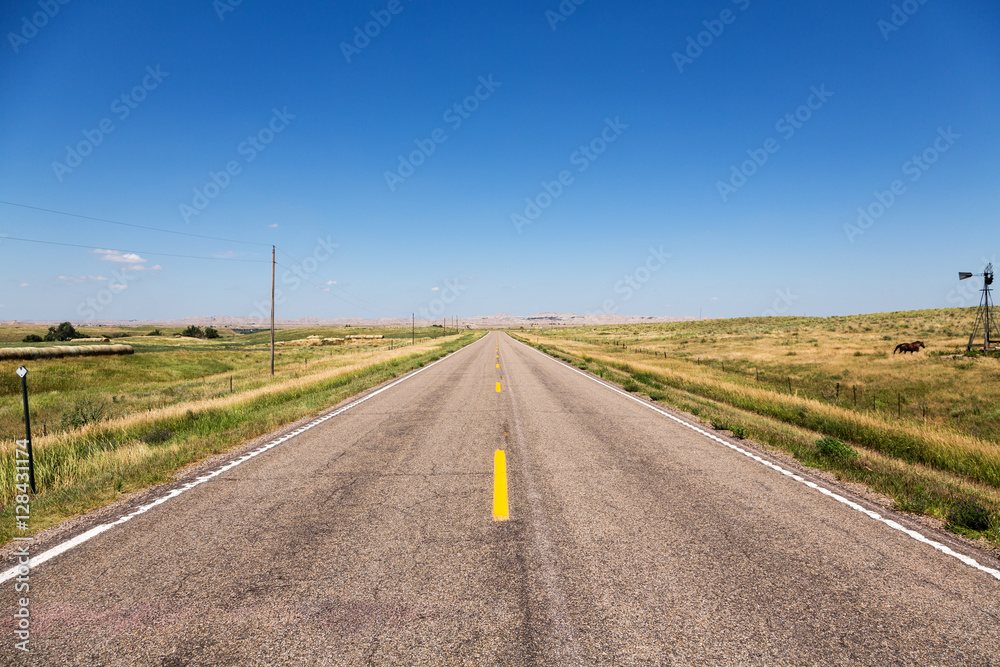 A road cutting through northern Nebraska on a summer day.