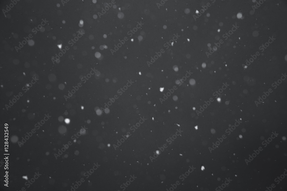Fototapeta premium Falling snow on black background.